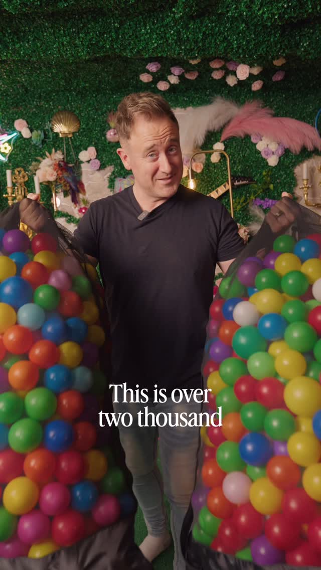 Scottie holding two bags of colourful balls